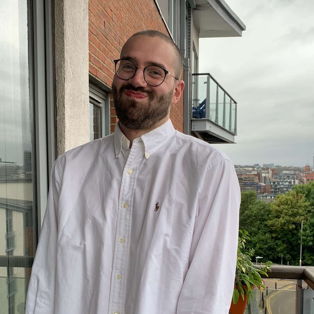 Dan on a balcony smiling